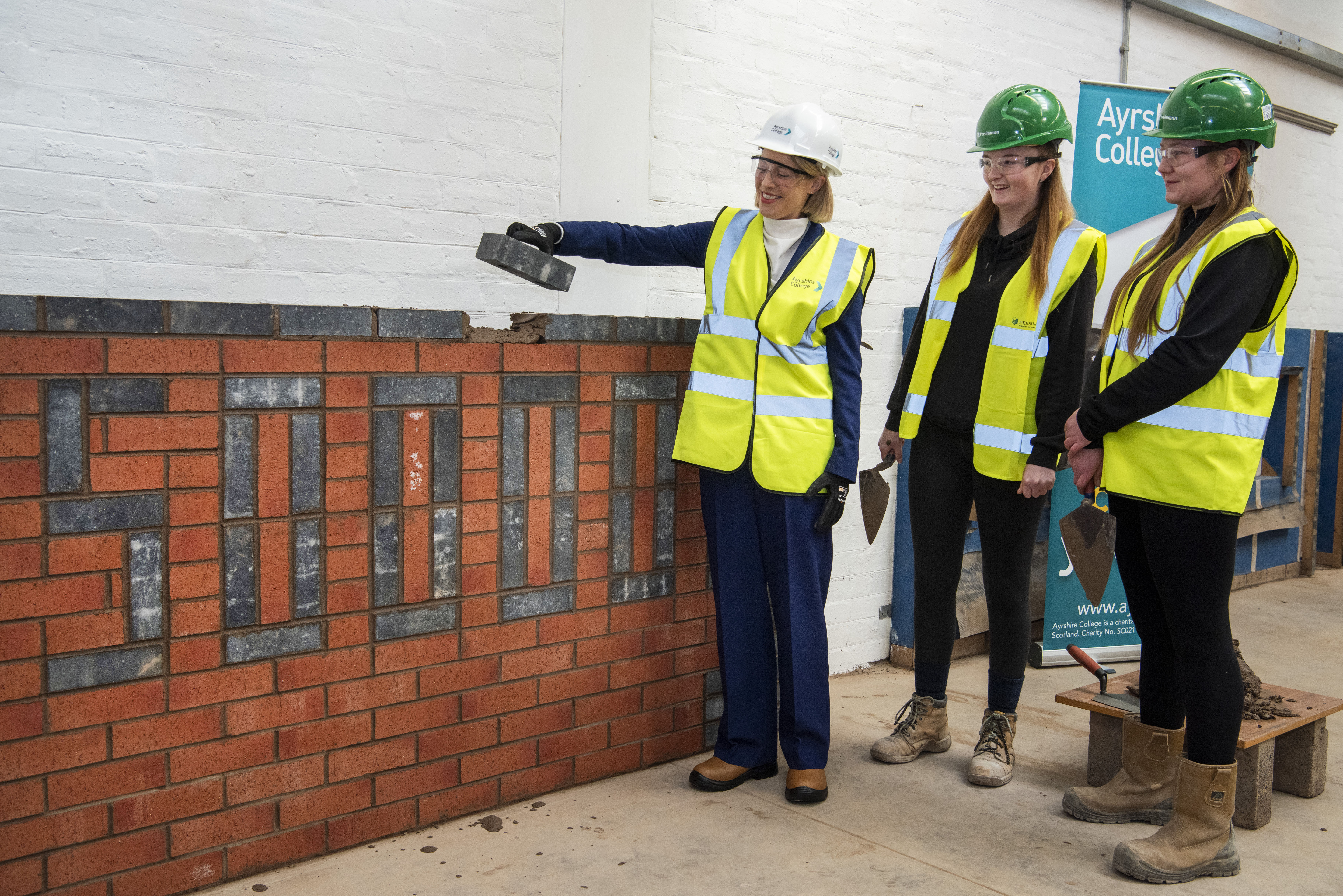 Cabinet secretary college visit marks Persimmon's 50,000th brick donation