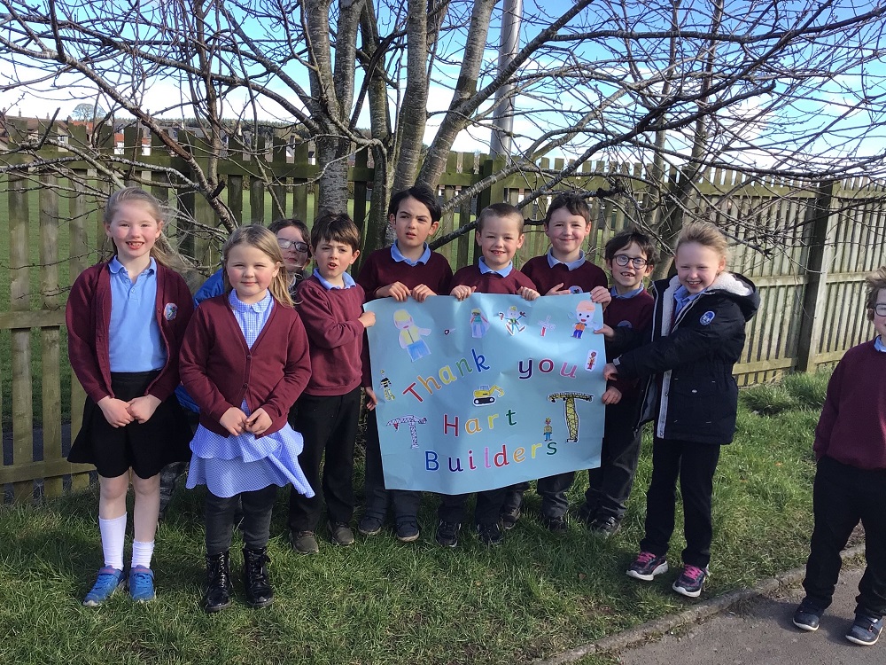 School children near BHA development welcome Hart Builders donation